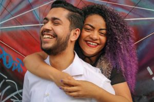 a woman hugging a man from the back